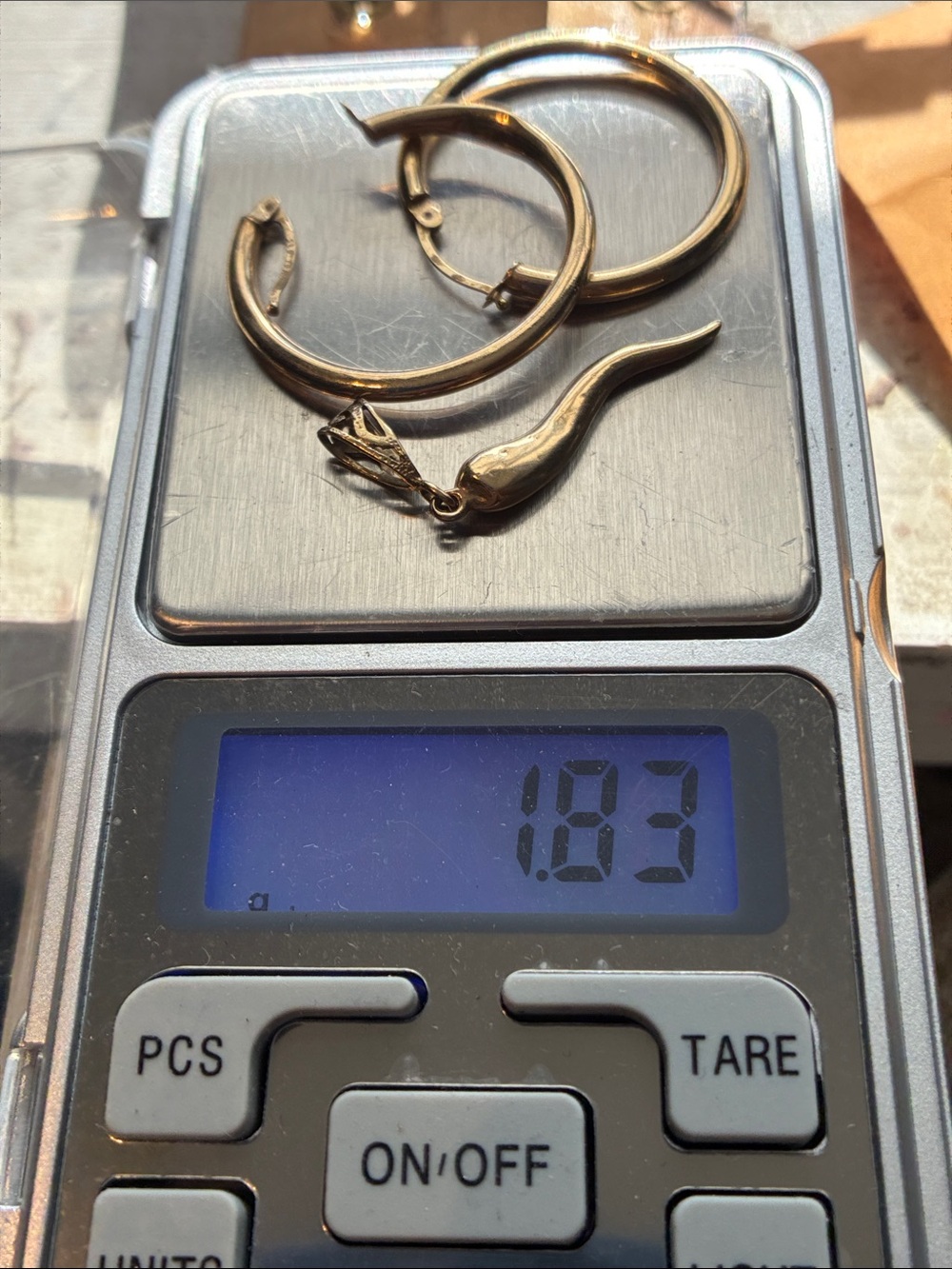 14k Pendant and a Pair of 10 K Hoops totaling 1.83 Grams.(Small dents)
